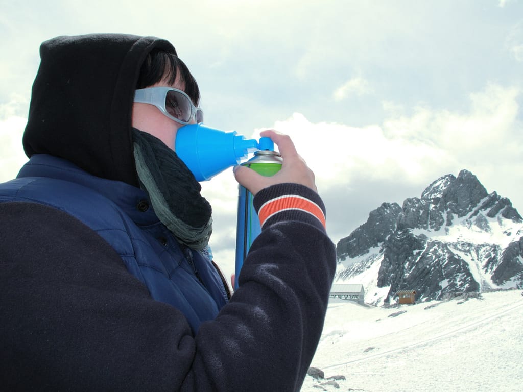 women using oxygen mask due to altitude sickness